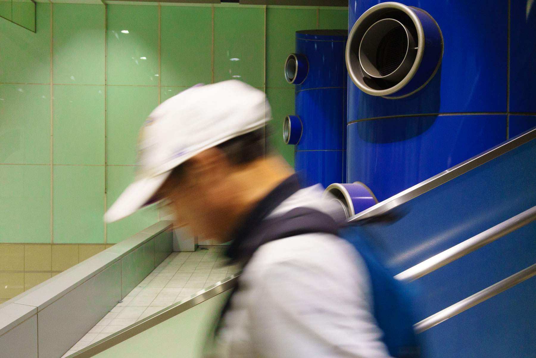 man walking down an escalator